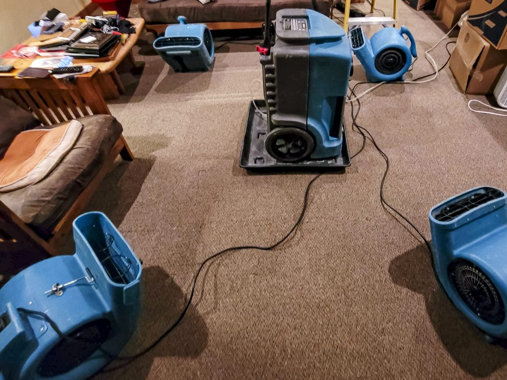 Water damaged home being dried out with air movers and a dehumidifier